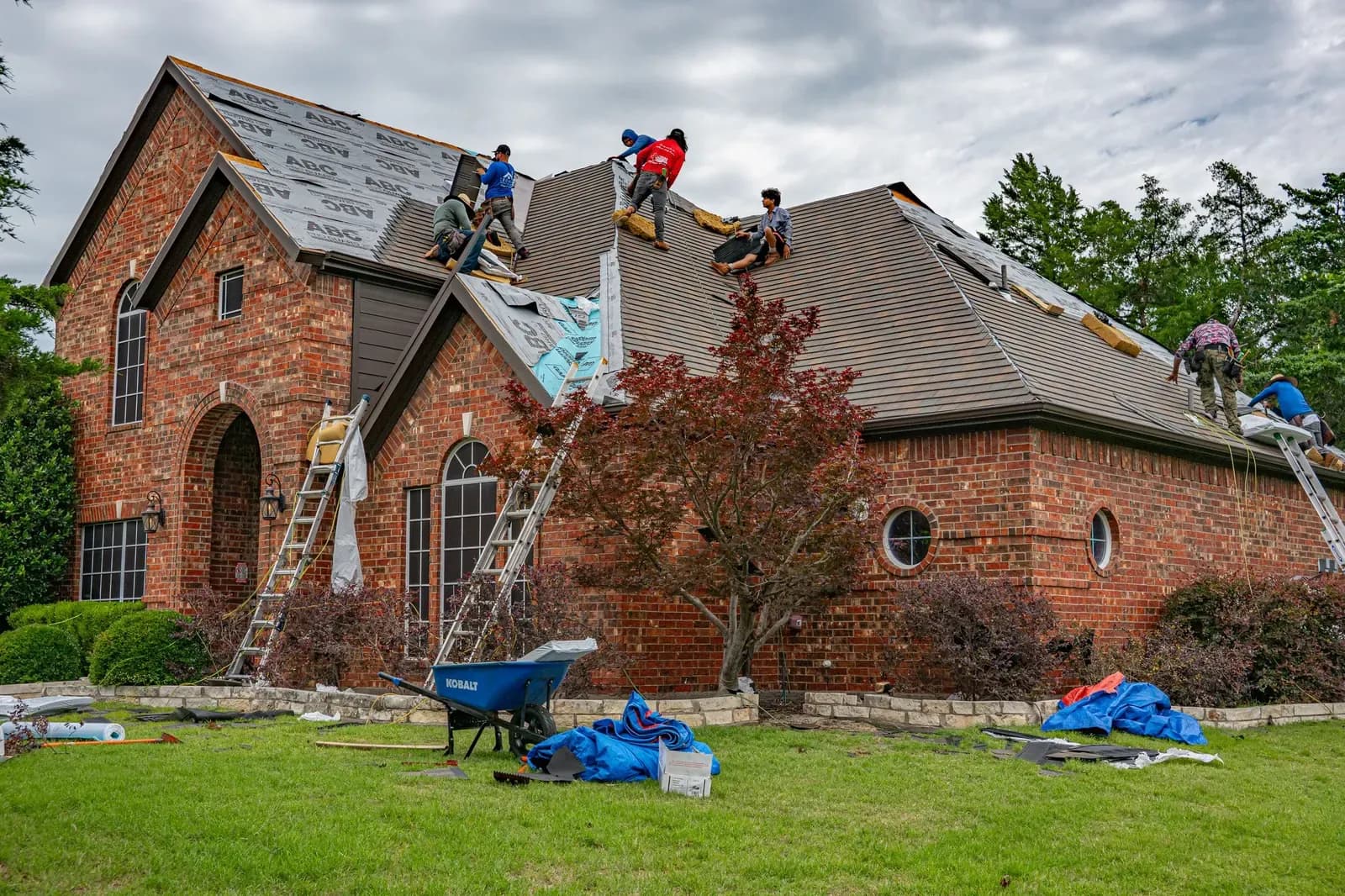Roofing crew working on a brick home