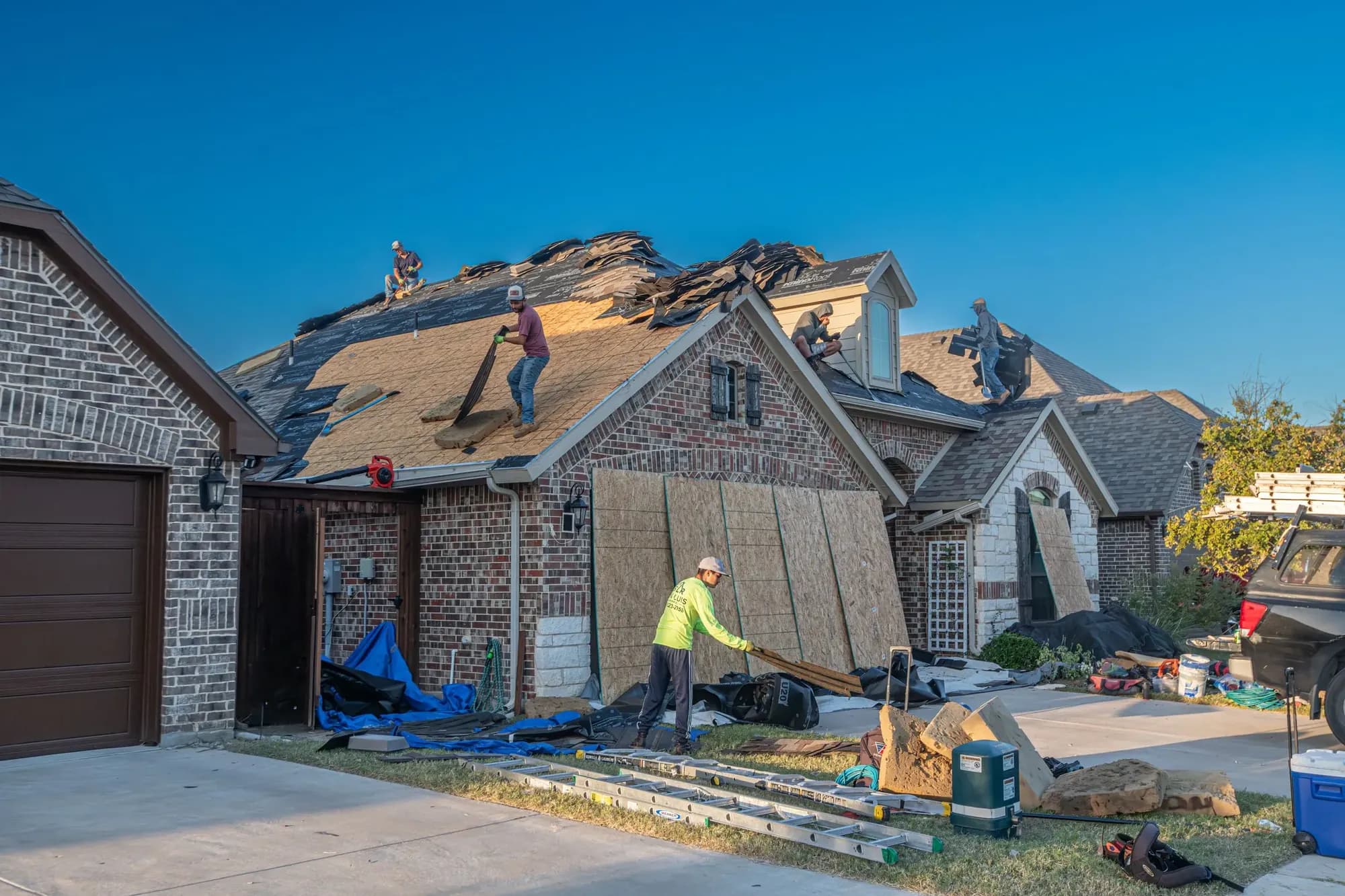 Roofing crew tearing off an old roof