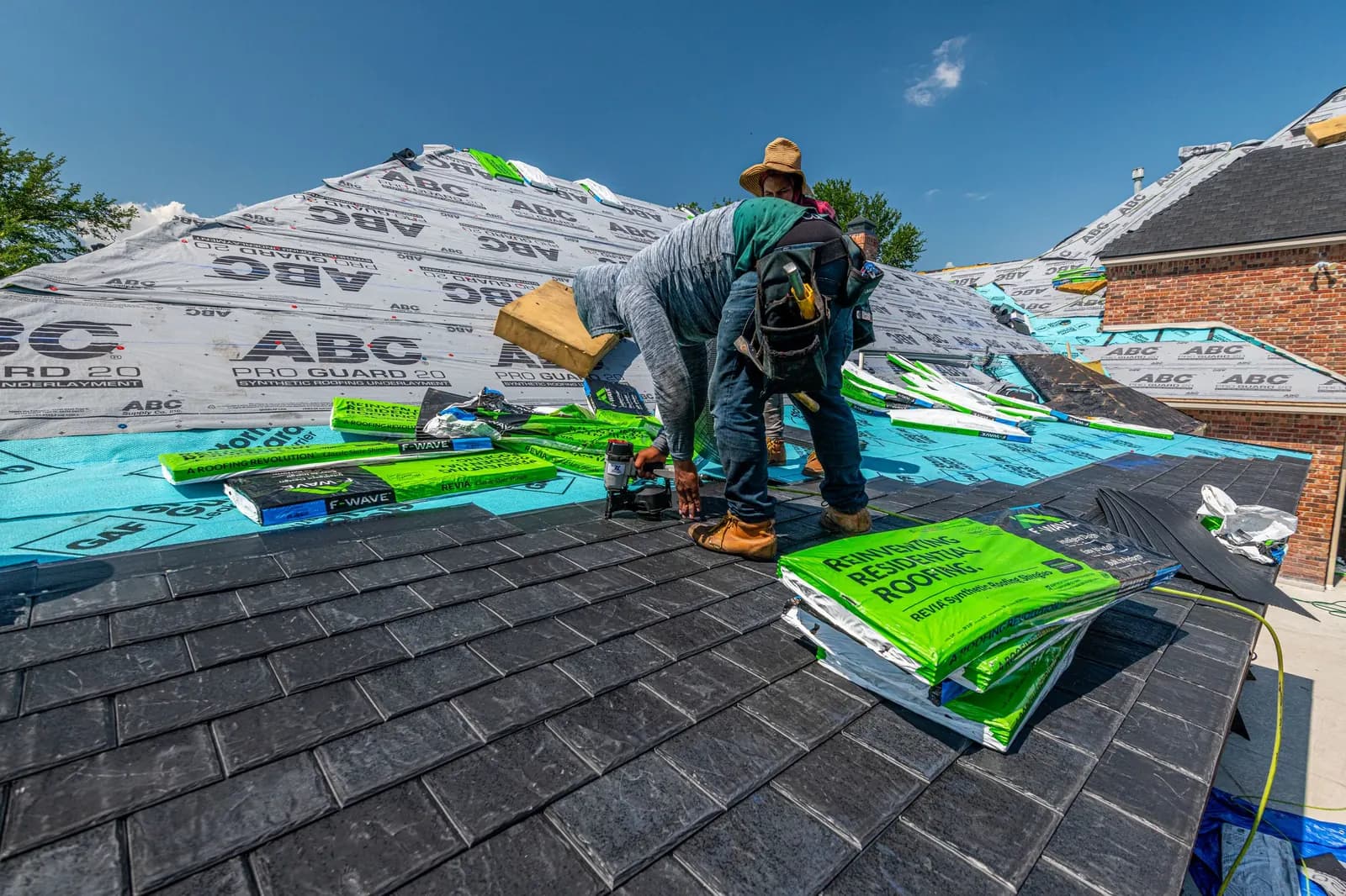 Roofers laying new shingles